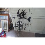 A wrought iron weather vane, decorated swallows 107.5cm