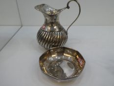 A silver jug with half reeded decoration, marked H and A  100, along with a silver Octagonal dish ma