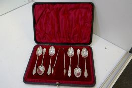 A cased set of six decorative Victorian silver spoons and a pair of silver tongs. With a twisted han