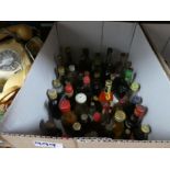 Three small boxes containing miniature alcohol bottles