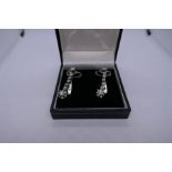 Art Deco Platinum and white gold drop earrings, each hung with seven diamonds approx 1 carat diamond