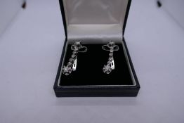 Art Deco Platinum and white gold drop earrings, each hung with seven diamonds approx 1 carat diamond