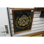 A tapestry emblem, framed and glazed, 'Honi Soit-Qui-Mal-y-Pense' insignia meaning 'shame to him who
