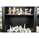 A quantity of Beswick Rupert Bear figures and similar, some limited edition, and a shelf of armorial