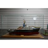 A ship's model of SMII Rotterdam Tug boat, in glazed case, 106cm