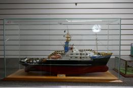 A ship's model of SMII Rotterdam Tug boat, in glazed case, 106cm