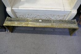 An antique brass fire kerb, probably 1920's having Oriental style decoration, 122cms