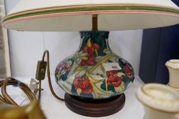 A Moorcroft squat lamp decorated flowers