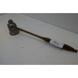 A silver candle snuffer with wooden handle, hallmarked London 1998 JA