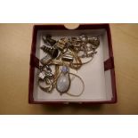 A collection of silver charms, to include a WANG HING example, a silver moonstone pendant, etc