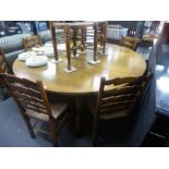 Titchmarsh & Goodwin, a large oak two flap gateleg table, 182 cm and a set of 8 wavy ladderback dini