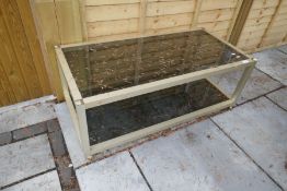 A metal framed glass 2 tier coffee table