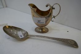 A silver gilt small jug hallmarked Birmingham 1910, The Alexander Clark Manufacturing Co. And a Geor