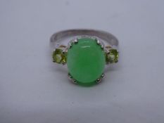 Silver dress ring with cabochon jade stone flanked 2 peridot, marked 925, size Q