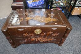 A Chinese carved camphor wood blanket box