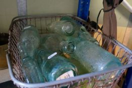 A basket of old green bottles