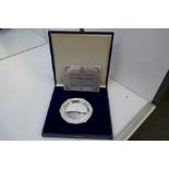 A Silver Jubilee trinket dish decorated with embossed, ornate design with an authentic paper within