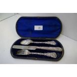 A very nice Victorian silver cased set of a spoon, fork and knife, heavily decorated with floriated