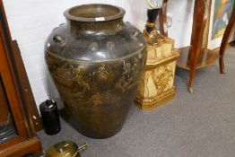 An old Chinese glazed stoneware urn with central border decorated Dragons, 71cm