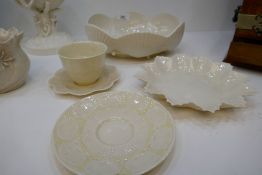 A Beleek clam shell oval bowl, a Beleek cup and saucer and two other items