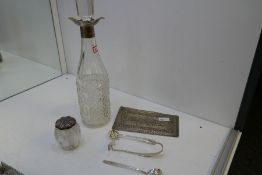 A selection of items to include a silver topped cut glass pot, a silver pusher, two silver spoons, o