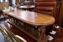 A long mahogany table having 4 elephant supports, 167cm