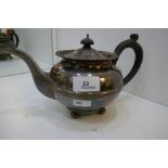 A heavy silver teapot with gadrooned rim on four ball feet, hallmarked London 1938 F T Ray and Co, t