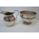 A silver milk jug with gadrooned rim, hallmarked Birmingham 1906 George Unite and Sons. Along with a
