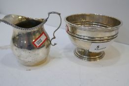 A silver milk jug with gadrooned rim, hallmarked Birmingham 1906 George Unite and Sons. Along with a