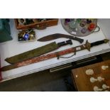 A reproduction sword, a machete and a Kukri