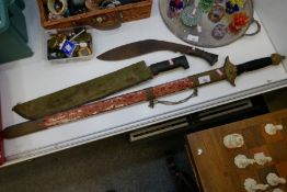 A reproduction sword, a machete and a Kukri