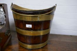 A Georgian mahogany brass bound bucket of oval form, with swing handle and later brass liner, 36.5cm