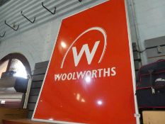 Large framed red 'Woolworths' advertising sign