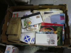 A box of First Day Covers and loose stamps