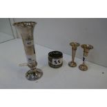 A silver hand hammered design flute vase 15cm approx. Along with two silver miniature candlesticks,