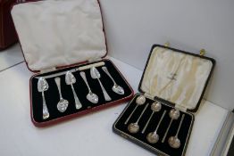 A cased set of six silver coffee spoons, and another set of six cased silver grapefruit spoons and a