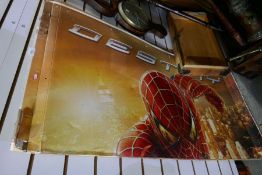 A large cardboard Spider Man advertising sign and a square print of musicians