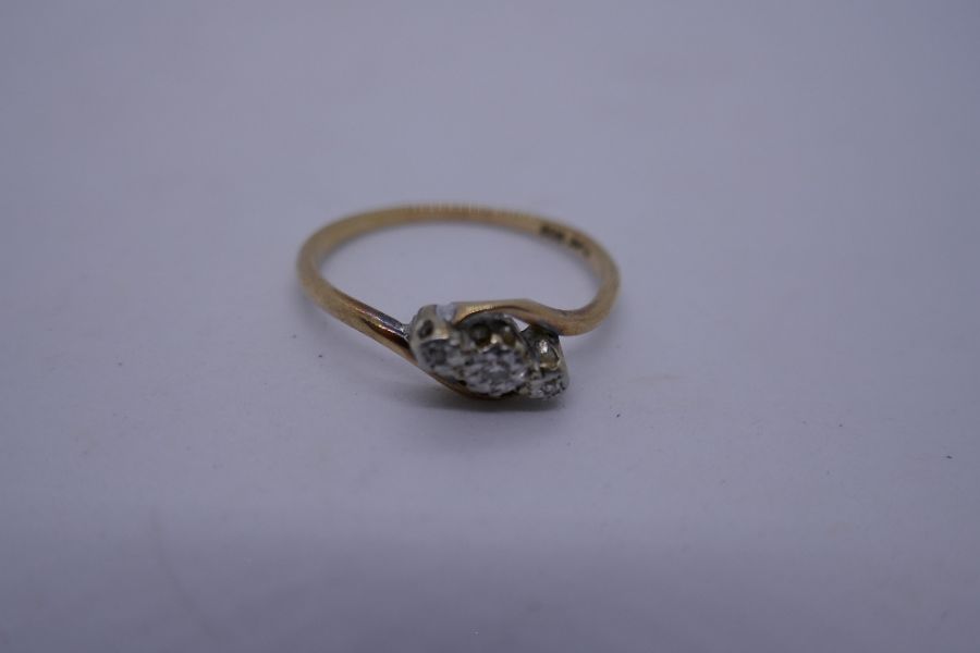 9ct yellow gold crossover design ring set with 3 diamonds in Platinum mount marked '9ct and Plat' si