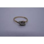 9ct yellow gold crossover design ring set with 3 diamonds in Platinum mount marked '9ct and Plat' si