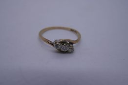 9ct yellow gold crossover design ring set with 3 diamonds in Platinum mount marked '9ct and Plat' si