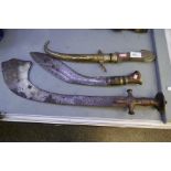 An Islamic sword having curved blade, engraved handle, a Kukri and a Middle Eastern dagger