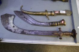 An Islamic sword having curved blade, engraved handle, a Kukri and a Middle Eastern dagger