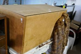 Plywood blanket box and a fur coat