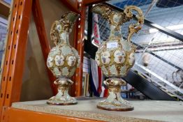 A pair of decorative china jugs, painted with grapes and leaves