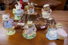 Six Beswick Beatrix Potter figures on tree stump base