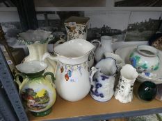 A shelf to include jugs, stoneware hot water bottles, small patterned rug, etc