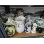 A shelf to include jugs, stoneware hot water bottles, small patterned rug, etc