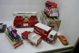 A quantity of vintage tin plate fire engines, Coca Cola trucks and train