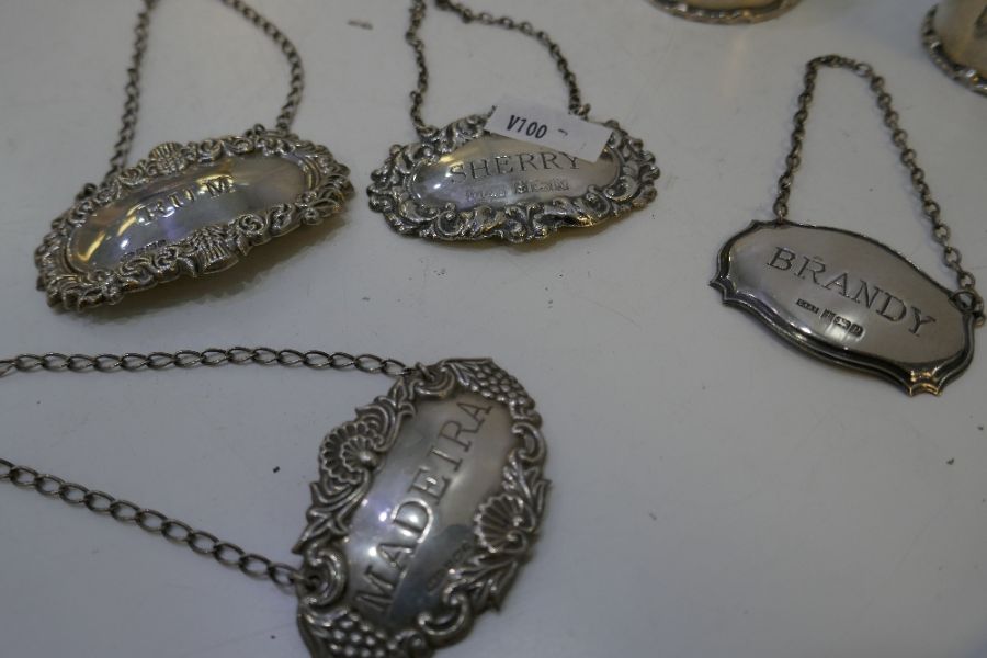 Four silver decanter labels of ornate decoration and various hallmarks and a pair of thick, silver n - Image 13 of 13