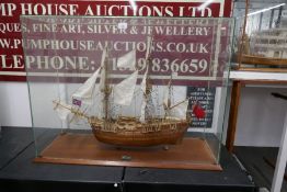 A kit built model of HMS Endeavour in glass case, with mahogany base, 96cm